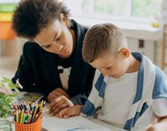 Tutor helping a student with homework at a desk